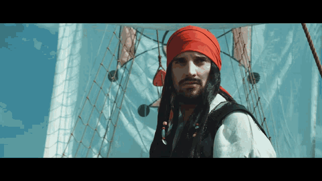 a man in a pirate costume with dreadlocks and a red bandana