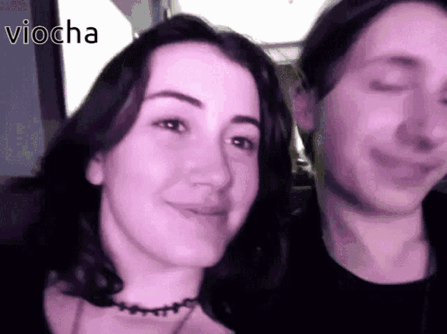 a man and a woman are standing next to each other and the word viocha is on the bottom