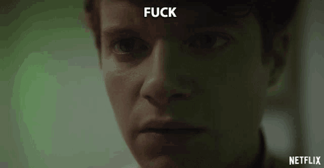 a close up of a man 's face with the word fuck written above him