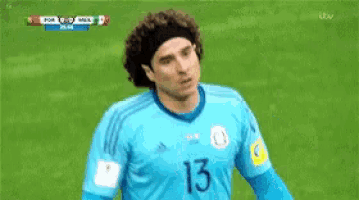 a soccer player wearing a blue jersey with the number 13