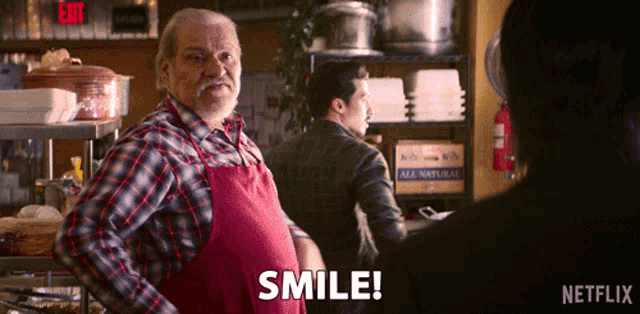 a man in an apron says smile in front of a netflix logo