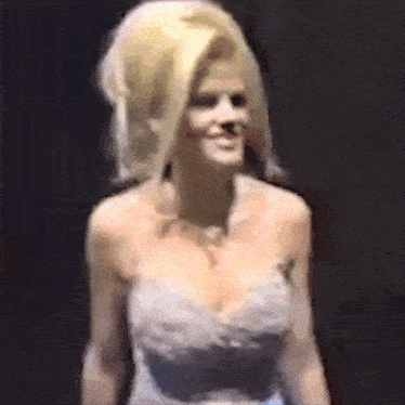 a woman with blonde hair and a very large wig