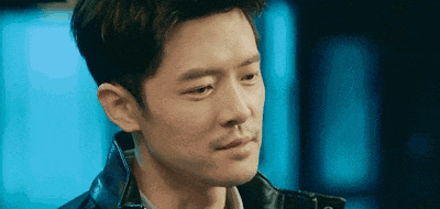 a close up of a man 's face with a blue background