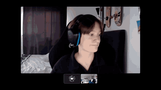 a man wearing headphones is sitting on a bed