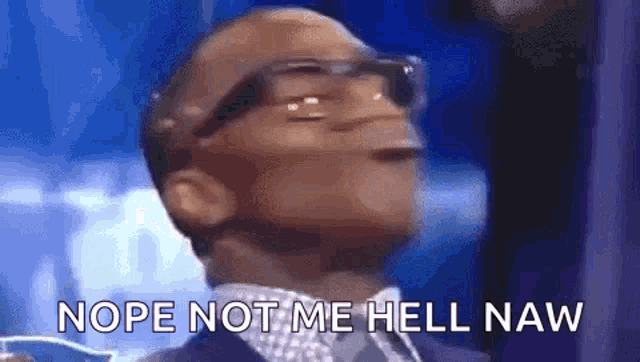 a man wearing glasses and a suit is making a funny face and saying nope not me hell naw .