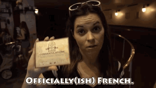 a woman is holding a card that says congratulations on it