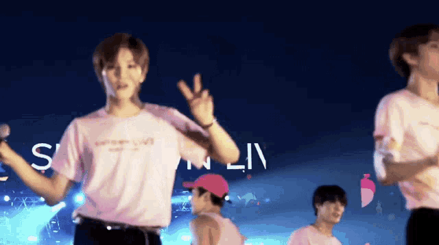 a man wearing a pink shirt that says s on it