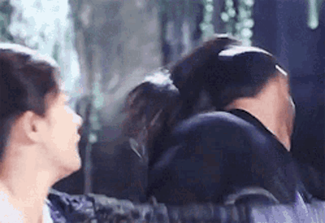 a man and a woman are standing next to each other .