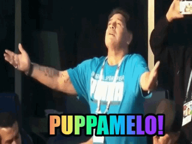 a man with his arms outstretched is wearing a blue shirt with the word puma on it