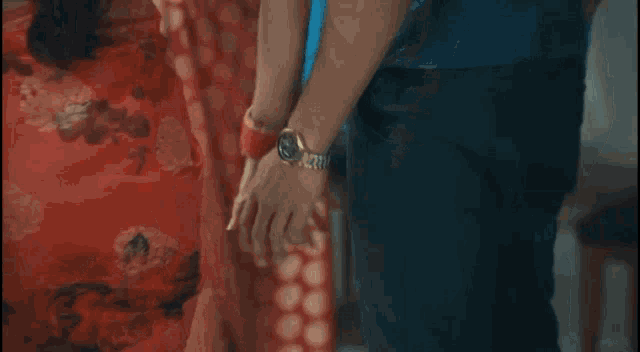 a man and a woman are holding hands in a living room