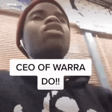 a man wearing a beanie and headphones is making a funny face with a sign that says ceo of warra do