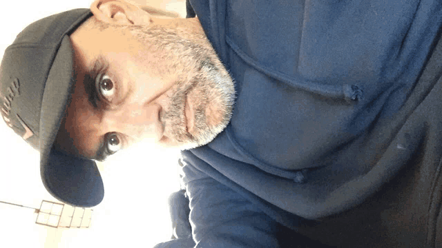 a man with a beard wears a hat that says ' chicago ' on it