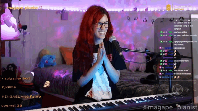 a woman with red hair is sitting at a keyboard and smiling