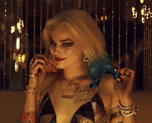 a woman with a tattoo on her chest that says " daddy 's little monster "