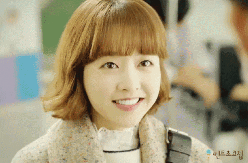 a close up of a woman 's face with korean writing on the bottom left corner