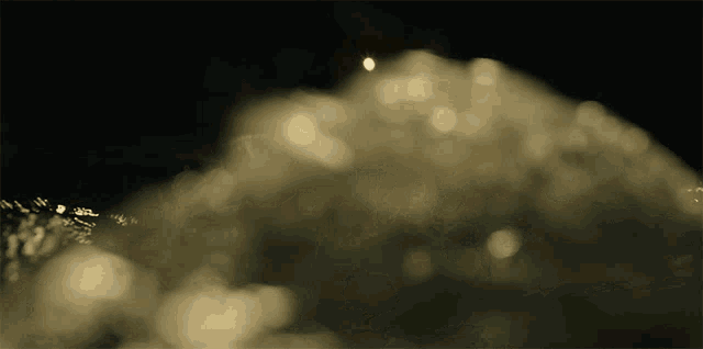 a blurred image of a mountain with a light shining through it