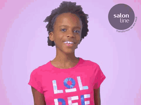 a young girl wearing a pink lol shirt