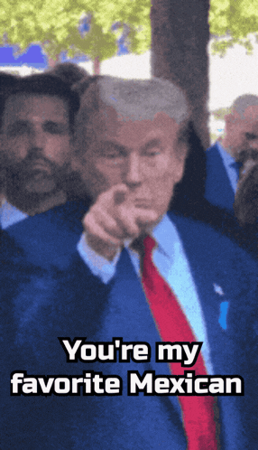 a man in a suit and tie is pointing at the camera with the words you 're my favorite mexican below him