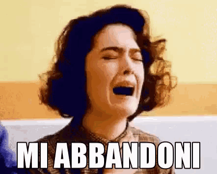 a woman is crying and the words mi abbandoni are above her