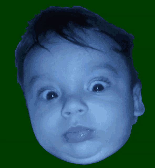 a baby 's face is against a green background and looks surprised