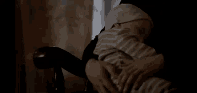 a person is holding a baby in their arms and the baby is wearing a white hat