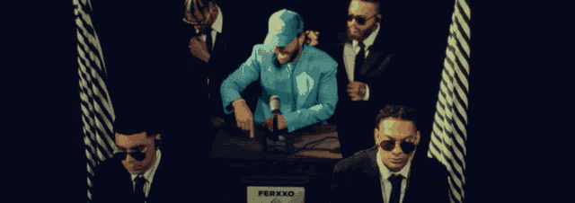 a group of men are standing around a box that says ferxxo on it