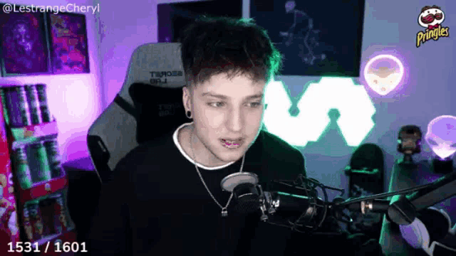 a man sitting in front of a microphone with the number 1531 / 1601 on the bottom right