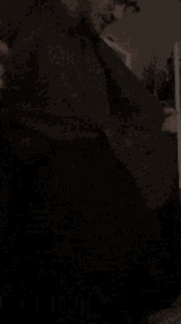 a man in a suit and tie is sitting down