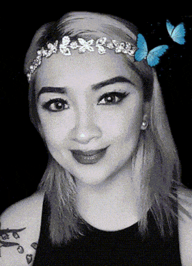 a woman wearing a headband with flowers and butterflies in her hair