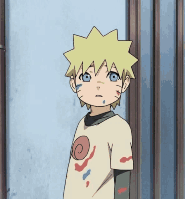 a young boy with yellow hair and blue eyes is wearing a white t-shirt with a spiral on it