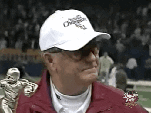 a man wearing a white national champions hat