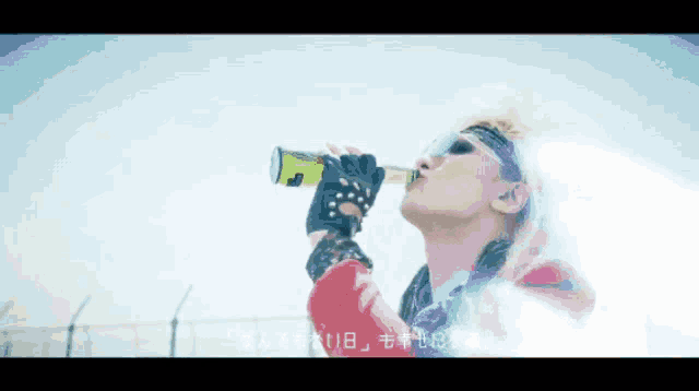 a man drinking from a green bottle with the number 11 on it