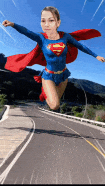 a woman in a superman costume is flying through the air