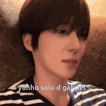 a close up of a person 's face with yunho solo d gabriel written on the bottom