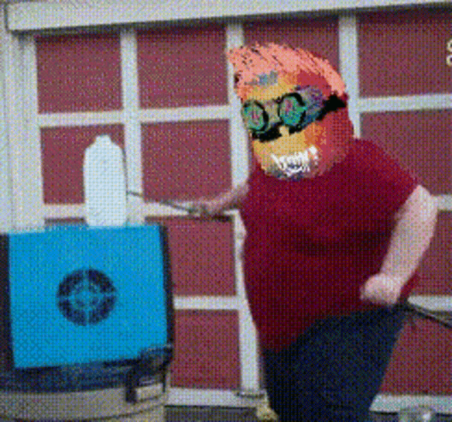 a person in a red shirt with a colorful mask on their head