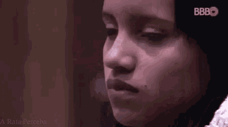 a close up of a woman 's face with her eyes closed .