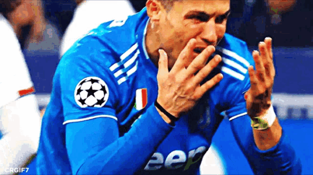 a soccer player wearing a blue jersey with jeep on it