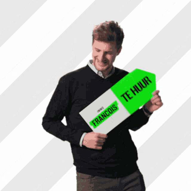 a man is holding a sign that says francois te huur