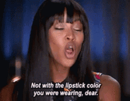 a woman with her eyes closed is saying not with the lipstick color you were wearing dear