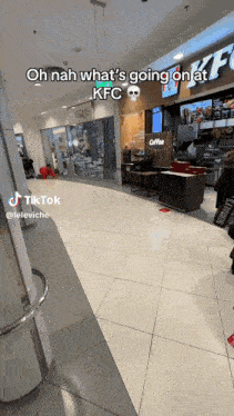 a tiktok video of a person standing in front of a kfc restaurant .