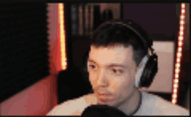a blurry picture of a man wearing headphones talking into a microphone