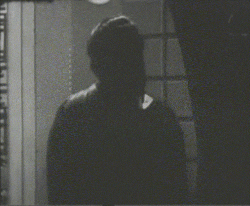 a black and white photo of a man 's face