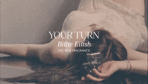 a poster for billie eilish 's new fragrance shows a woman laying on the floor