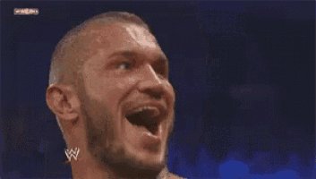 a man is making a funny face with his tongue out and a w logo in the background .
