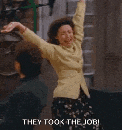 a woman is dancing in a hallway with her arms in the air and the words `` they took the job '' .