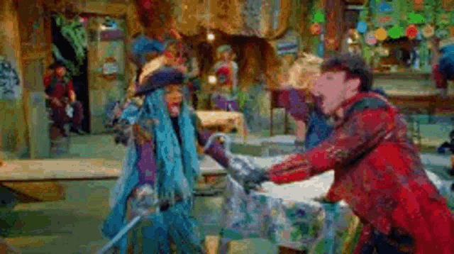 a man and a woman are holding swords in a room .