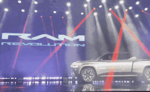 a ram revolution truck is being displayed on stage