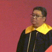 a man in a graduation gown with a yellow collar