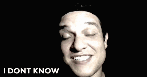 a man making a funny face with the words what the heck written below him
