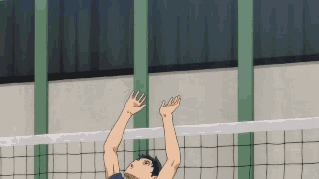 a man in a blue shirt is jumping in the air to hit a volleyball